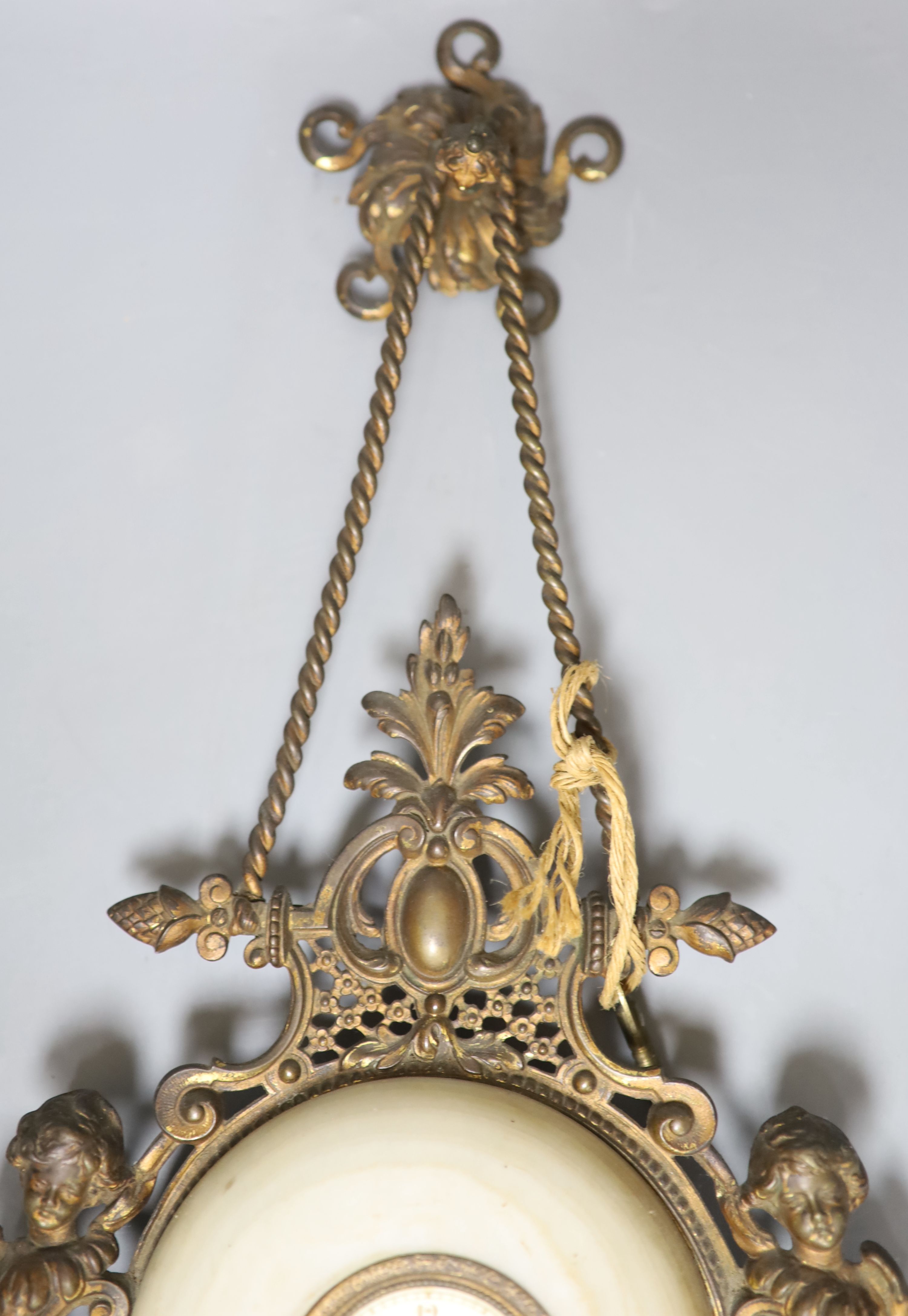 A French gilt metal, onyx and enamelled wall clock, length 49cm